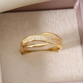 Eleganter goldfarbener Crossover-Ring mit Steinen